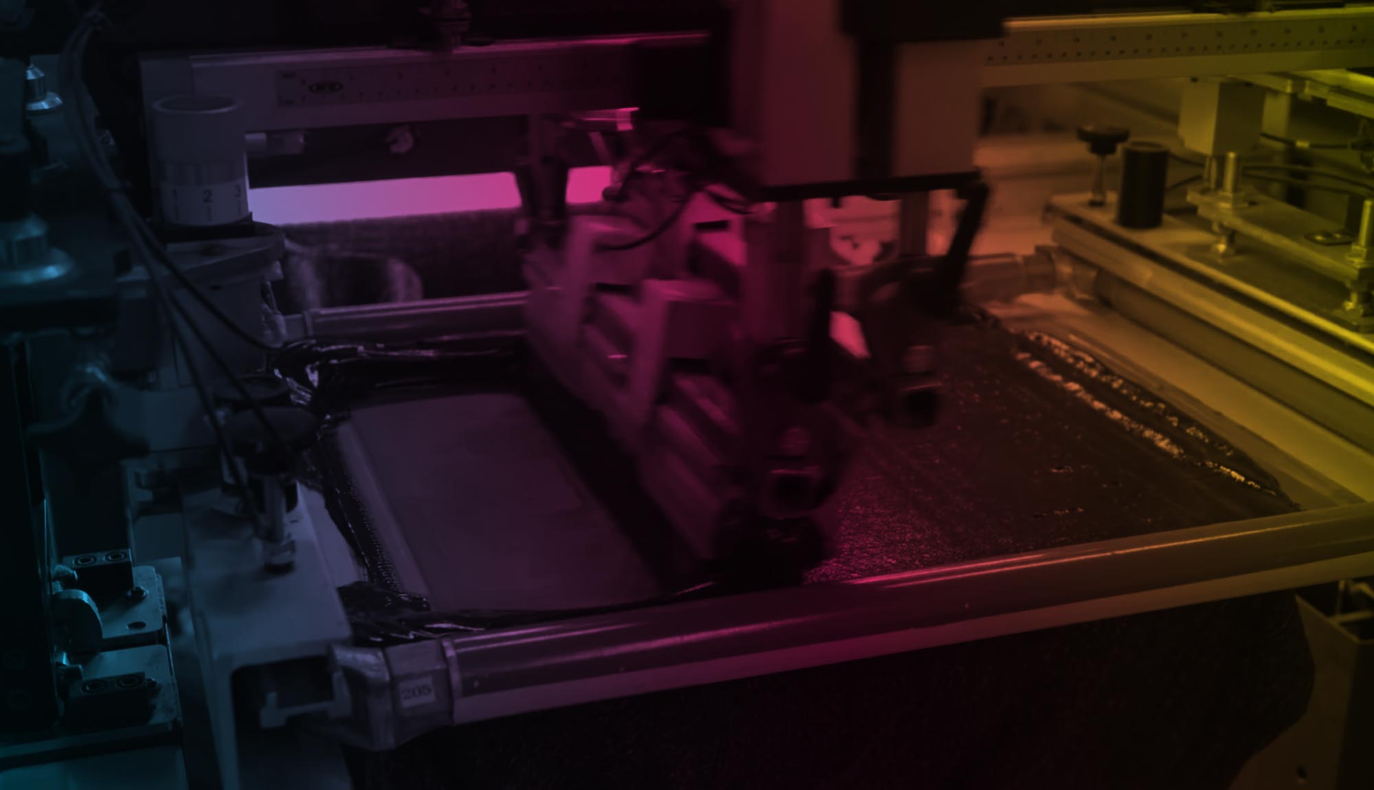 Squeegee pulling ink across a screen at Print Hybrid